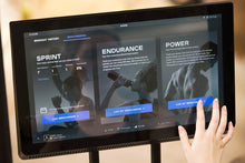 Woman using connected display on the new CLIMBR with touch screen