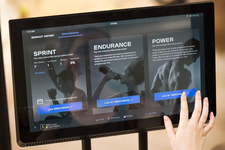 Woman using connected display on the new CLIMBR with touch screen